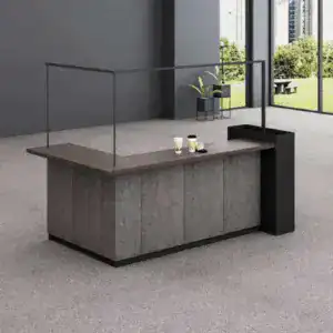 Reception desk with a dark finish, featuring a raised counter and glass partitions in a modern office setting.
